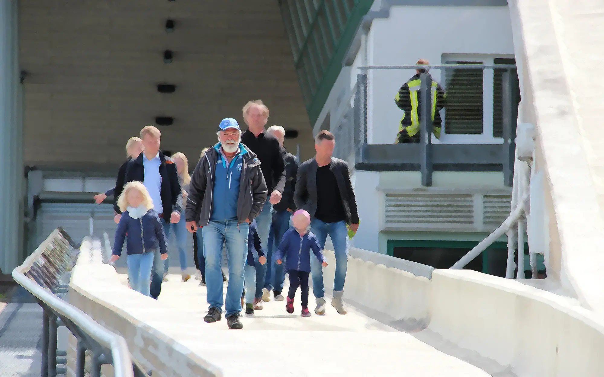 Eine Gruppe aus Erwachsenen und Kindern läuft hinter dem Bobbahnführer her durch den Eiskanal.