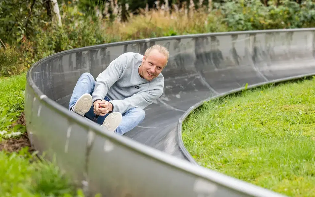 Ein Mann fährt rasant durch eine Kurve der Sommerrodelbahn.