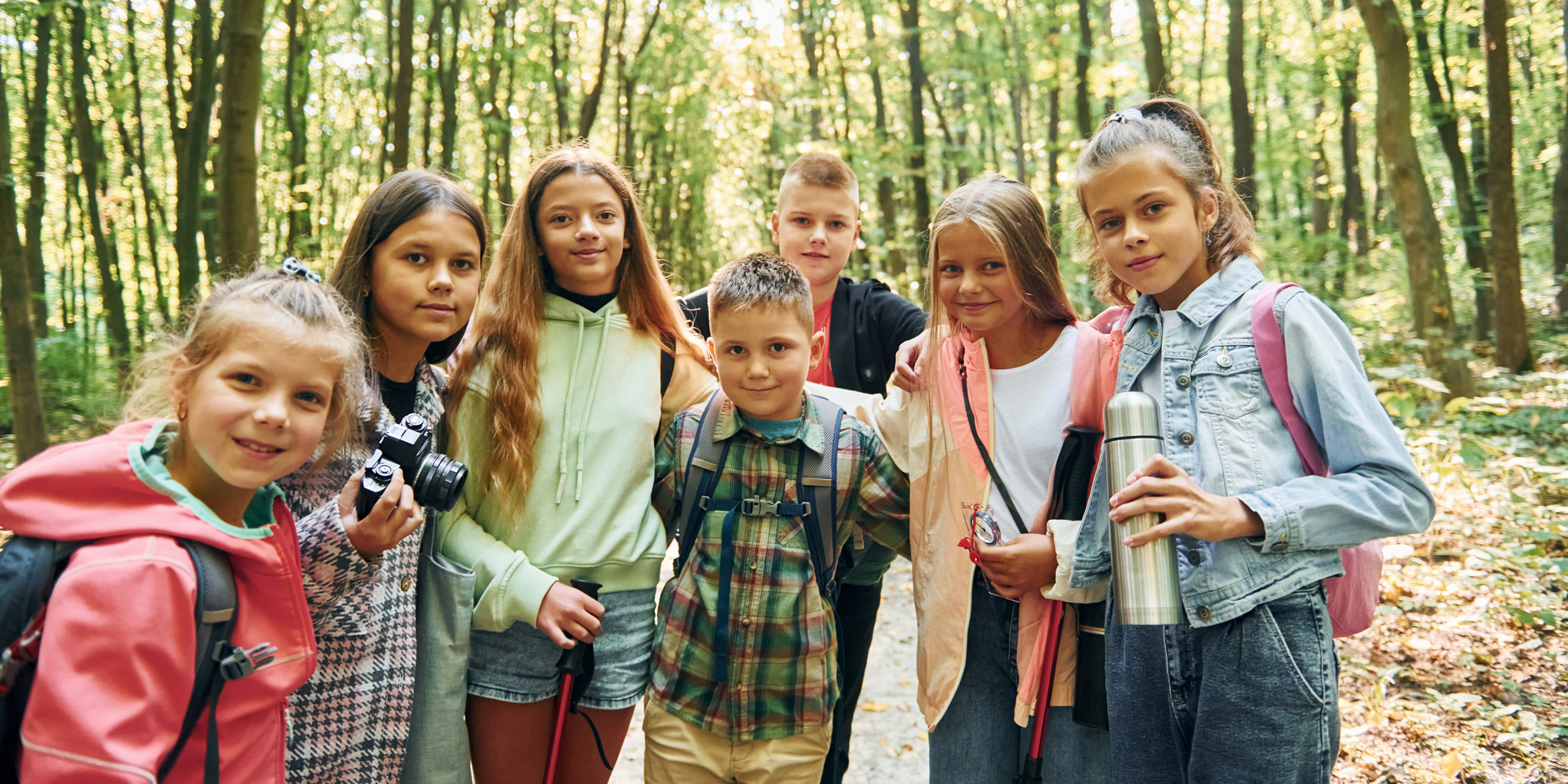 Sommerferienprogramm 2026 Eine Gruppe Kinder spielt im Wald